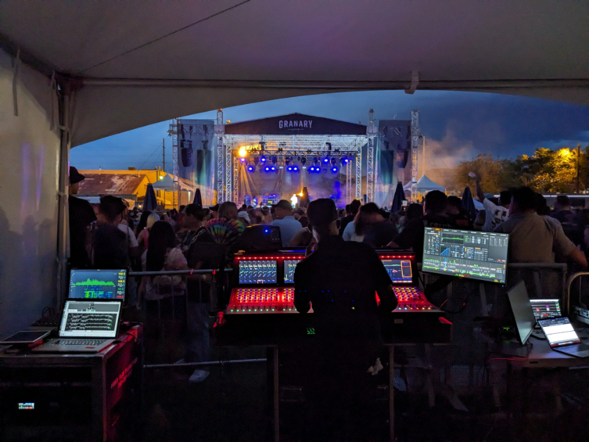 Audio engineer operating a digital console from the production booth during a live show at Granary Live in Salt Lake City.