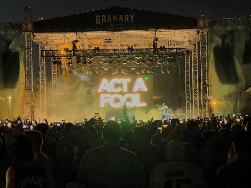Live band performing under intense red lighting at Granary Live outdoor venue with full stage and audience view.